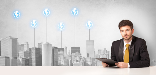 Announcer sitting at desk presenting the city energy consumption
