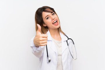 Young doctor woman over isolated background with thumbs up because something good has happened