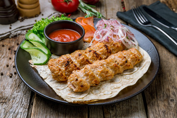 Lula kebab chicken on black plate