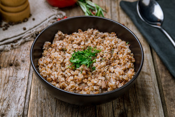 boiled buckwheat porridge on black bowl