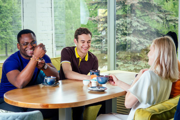 Fototapeta premium multinational group of happy friends enjoy and drinking tea cafe .