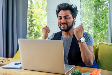 handsome and successful surprised amazed businessman student in a stylish well-dressed freelancer working with a laptop .freelance and remote work.