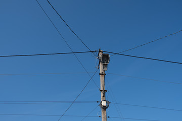 Street lamppost with wires. Concrete pole with a lantern. Street lamp without lamp.
