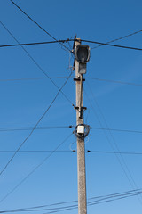 Street lamppost with wires. Concrete pole with a lantern. Street lamp without lamp.