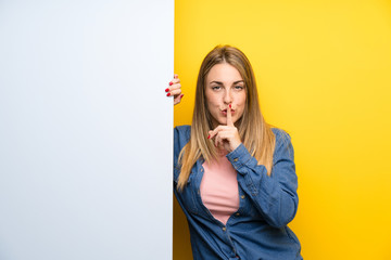 Young woman holding an empty placard showing a sign of closing mouth and silence gesture