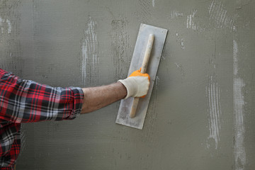 Wall insulation, spreading mortar over mesh and styrofoam
