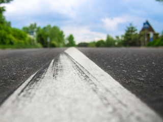 Two-way asphalt road in the countryside, close-up of the dividing strip