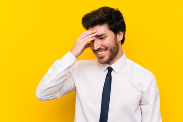 Businessman on isolated yellow background laughing