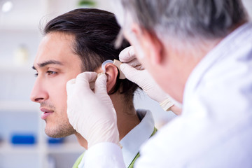 Male patient with hearing problem visiting doctor otorhinolaryng