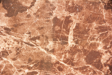 marble brown decorative wall with patterns, stains and cracks