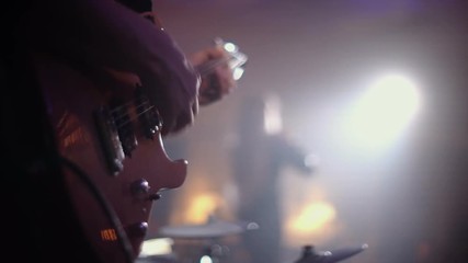 Guitarist plays on the background of the singer at a live concert - Powered by Adobe