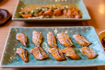 Set of Salmon Burn Aburi Sushi on Crockery Plate.