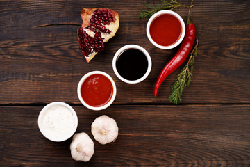 Selection of different sauces in bowls and ingredients. Culinary background, delicious food