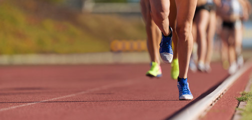 Group of athletes sprinters run speed on track of stadium