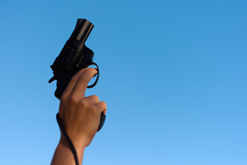 A hand shotting a gun for starting race