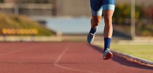 Man runner running on track of stadium