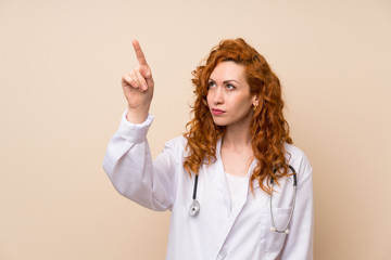 Redhead doctor woman touching on transparent screen