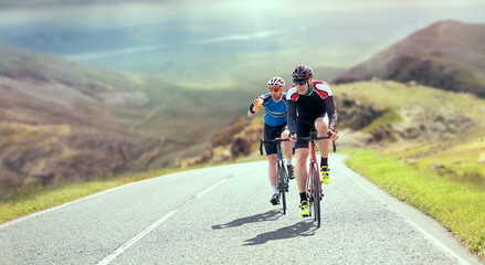 Cyclists out racing along country lanes in the mountains in the United Kingdom.