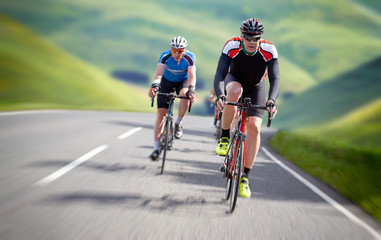 Naklejka na ściany i meble Cyclists out racing along country lanes in the mountains in the United Kingdom.