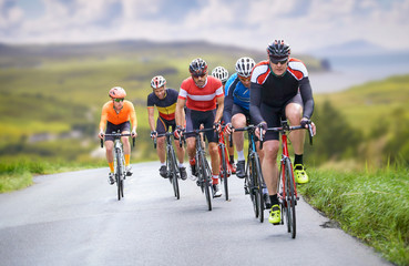 Cyclists out racing along country lanes near the coast in the United Kingdom - obrazy, fototapety, plakaty