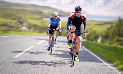 Fototapeta na wymiar Cyclists out racing along country lanes near the coast in the United Kingdom