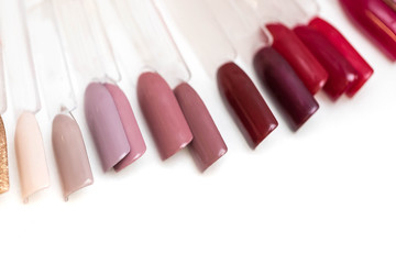 Palette with different color of a varnish covering for finishing finishing of nails in beauty shop...