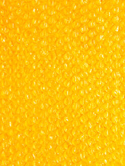 plastic background texture cellophane wrapping packing wrap packet bead ball brilliant orange yellow hot sun