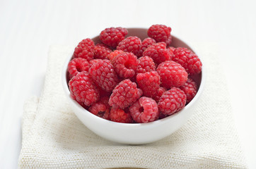 Raspberries in white bowl
