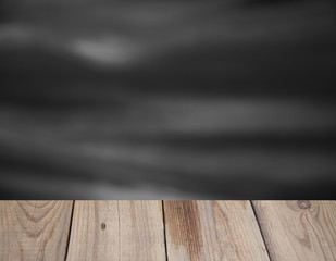 black background on the wall with wooden table