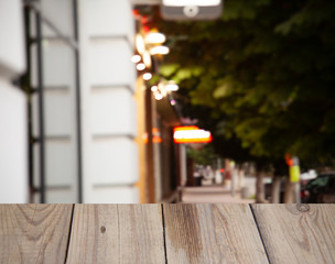 blurred cafe background with light bulbs with wooden table