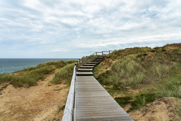 Fototapeta na wymiar Sylt - View from boardwalk to Grass- and Sand-Dunes at Kampen Cliff / Germany