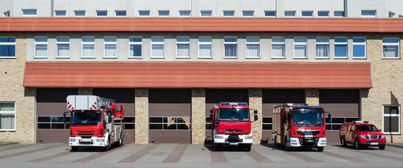 Fototapeta premium FIRE BRIGADE - Rescue vehicles in front of the fire station building in Kolobrzeg