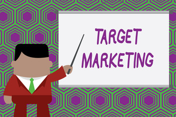 Conceptual hand writing showing Target Marketing. Concept meaning Audience goal Chosen clients customers Advertising Businessman standing in front projector pointing project idea