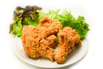 Fried chicken crispy on plate with salad lettuce on white