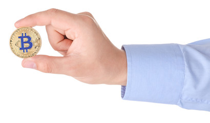 Man holding golden bitcoin on white background, closeup