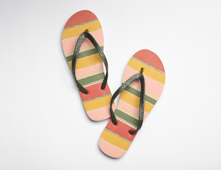 Pair of flip flops on white background, top view. Beach accessories