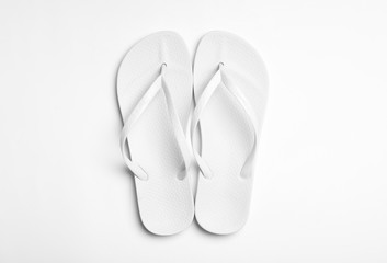 Pair of flip flops on white background, top view. Beach accessories