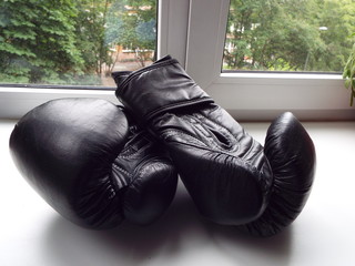 black Boxing gloves on a white windowsill