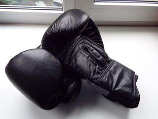 black Boxing gloves on a white windowsill