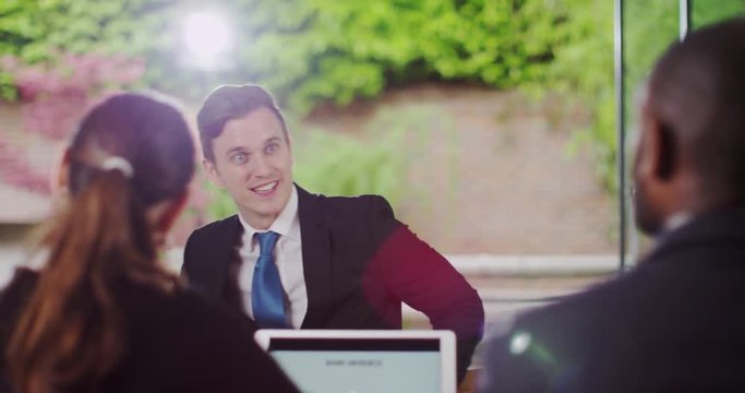 4K Businessman shaking hands & answering questions at corporate job interview. Slow motion.
