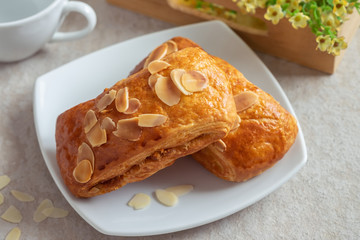 Almond danish pastry on white plate