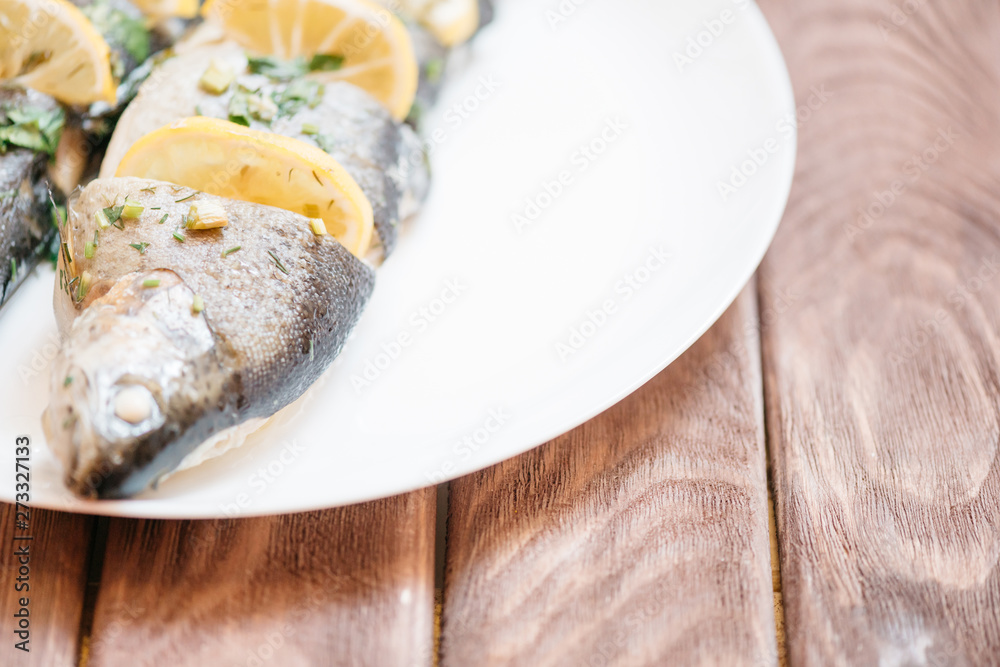 Wall mural Baked fish dish on a white plate.