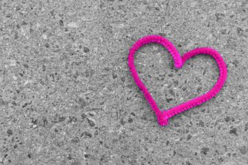 Fototapeta premium pink heart on asphalt greeting card background