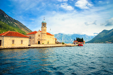 Fototapeta na wymiar Beautiful mediterranean landscape. Our Lady of the Rock Island near town Perast, Kotor bay, Montenegro.