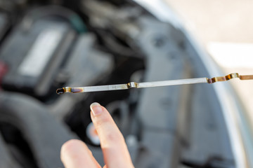 Car dipstick for oil level measurements. Checking the parameters of the car engine.