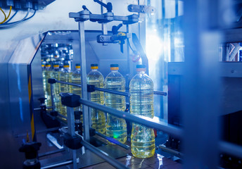 Bottling line of sunflower oil in bottles. Vegetable oil production plant. High technology.