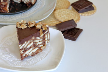 Cake without baking cookies and chocolate. Decorated with walnut crumbs.