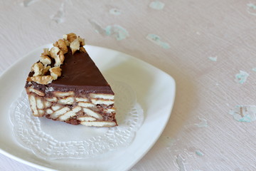 Cake without baking cookies and chocolate. Decorated with walnut crumbs.
