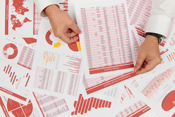 Obraz premium Flat top view of businessman working and calculating finance, reads and writes reports. Business financial accounting concept.