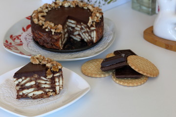 Cake without baking cookies and chocolate. Decorated with walnut crumbs.